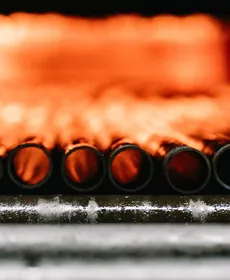 Stainless steel tube ends glowing inside the heat-treatment furnace