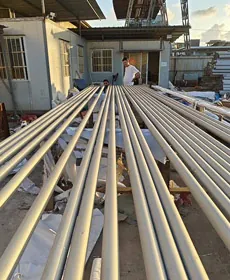 Seamless stainless steel pipes lined up for inspection in the factory yard