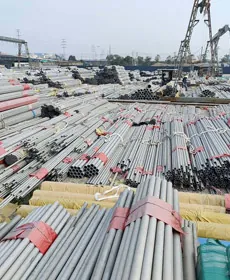 Strapped bundles of seamless stainless steel pipes in the open-air stock yard